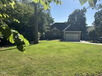 Charming single-story home with lush green lawn and attached garage, great curb appeal at 929 Sagamore Dr, Louisburg, NC 27549