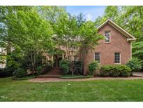 Charming brick home with lush landscaping and inviting entrance at 1003 Gloucester Ct, Chapel Hill, NC 27516