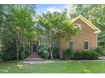 Charming brick home with mature trees, offering a tranquil and private setting at 1003 Gloucester Ct, Chapel Hill, NC 27516