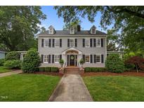 Charming two-story home with a well-manicured lawn and traditional architectural details at 1015 Watts St, Durham, NC 27701