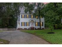 Charming two-story home featuring a well-manicured lawn and a curved driveway at 105 Houston Cir, Cary, NC 27513
