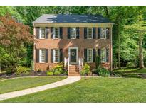 Charming brick home with black shutters and landscaped front yard at 1104 Berwyn Way, Raleigh, NC 27615