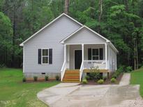 Charming single-story home with a covered front porch and well-maintained landscaping at 119 Oak Ridge Rd, Franklinton, NC 27525