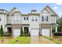 Charming townhomes boast brick accents, inviting garages, and well-manicured lawns at 127 Manordale Dr, Chapel Hill, NC 27517