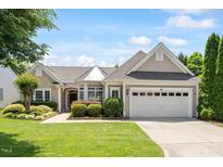 Charming single-story home featuring a well-manicured lawn, tidy landscaping, and an attached two-car garage at 1405 Ventnor Pl, Cary, NC 27519