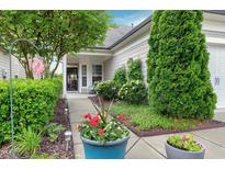 Charming home featuring a well-manicured lawn and vibrant landscaping, and a walkway to the front door at 1520 Palmer Hill Dr, Durham, NC 27703