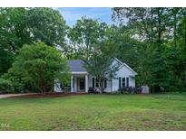 Charming single-story home featuring a well-manicured lawn and mature trees for added privacy at 175 Fox Run Rd, Youngsville, NC 27596