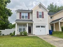 Charming two-story home featuring a one-car garage, landscaped yard, and inviting front porch at 1924 Barngate Way, Raleigh, NC 27614