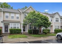 Charming townhouse with meticulously maintained landscaping, neutral exterior, and welcoming entrance at 214 Cedar Elm Rd, Durham, NC 27713
