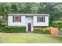 Charming two-story home with light blue siding, black shutters, and landscaped front yard at 2216 Lawrence Dr, Raleigh, NC 27603