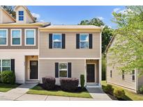 Inviting two-story townhome featuring neutral siding, dark shutters, and well-maintained landscaping at 246 Spark St, Raleigh, NC 27606