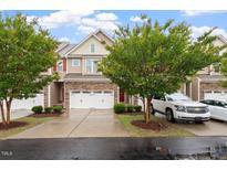 Charming townhome featuring a two-car garage and well-maintained landscaping at 270 Wembley Dr, Clayton, NC 27527