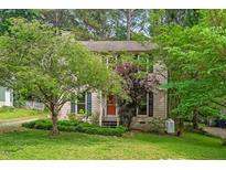 Charming home with a well-maintained lawn and mature trees providing ample shade at 3405 Bonaparte Way, Durham, NC 27707
