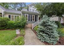 Charming home featuring a well-manicured front yard with a welcoming walkway and tasteful landscaping at 3940 Lake Ferry Dr, Raleigh, NC 27606