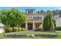 Charming two-story home with manicured lawn, stone accents, and a welcoming front porch at 528 Bankhead Dr, Cary, NC 27519