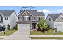 Beautiful two-story home with a well-manicured lawn and a two-car garage at 5292 Goosecross Way, Fuquay Varina, NC 27526