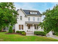 Charming two-story home with landscaped yard, covered porch, and classic white siding at 729 Mills St, Raleigh, NC 27608