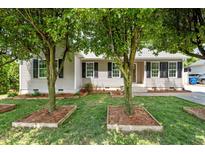 Charming single-story home with a well-maintained front yard, featuring black shutters and lush landscaping at 800 Linens St, Graham, NC 27253