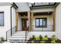 Inviting entrance with stone steps, wood columns, and dark window and railing accents at 8021 Bud Morris Rd, Wake Forest, NC 27587
