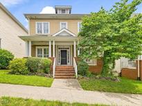 Charming two-story home with a welcoming front porch and well-manicured landscaping at 102 Westside Dr, Chapel Hill, NC 27516