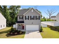 Charming two-story home with gray siding, black shutters, and a well-manicured lawn at 1028 Gallivant Way, Wake Forest, NC 27587
