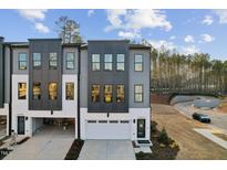 Modern townhome with gray and white exterior, featuring a two-car garage and contemporary design at 10518 Pleasant Branch Dr # 33, Raleigh, NC 27614