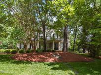 Beautiful two-story home featuring lush landscaping and inviting front porch, perfect for relaxing at 124 Creekvista Dr, Holly Springs, NC 27540