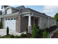 Charming home exterior with a brick accent wall, landscaped yard, and an inviting entrance at 143 Swain St, Clayton, NC 27527