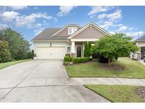 Charming single-Gathering home featuring a well-manicured lawn and a two-car garage at 1528 Anthology Dr, Durham, NC 27703