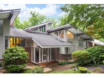 Striking modern home with unique architectural details, skylights, and professional landscaping for incredible curb appeal at 1604 Pinecrest Rd, Durham, NC 27705