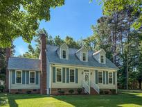 Charming two-story home with dormer windows, a well-manicured lawn, and classic architectural details at 20 Banbury Ct, Roxboro, NC 27573