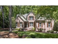 Charming brick home with lush landscaping, detailed shutters, and a welcoming front entrance at 205 Benwell Ct, Cary, NC 27519