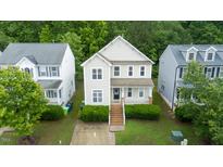 Charming two-story home with landscaped yard and inviting front porch at 2420 Sapphire Valley Dr, Raleigh, NC 27604