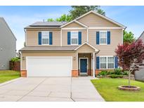 Charming two-story home featuring blue shutters, a well-maintained lawn, and a two car garage at 2622 Perthshire Ln, Fuquay Varina, NC 27526