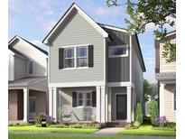 Charming two-story home with gray siding, black shutters, and a welcoming front porch with rocking chairs at 328 Cottage Hill Way, Raleigh, NC 27604