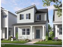 Charming two-story home featuring a welcoming front porch and beautifully landscaped yard at 336 Cottage Hill Way, Raleigh, NC 27604