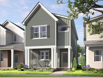 Charming two-story home featuring vertical siding, white trim, inviting front porch with rocking chairs and manicured lawn at 340 Cottage Hill Way, Raleigh, NC 27604