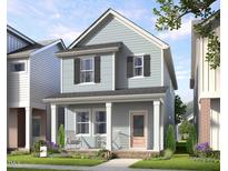 Charming two-story home with a cozy front porch, offering a welcoming curb appeal and a delightful outdoor space at 346 Cottage Hill Way, Raleigh, NC 27604