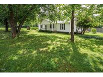 Charming single-story home with a well-maintained lawn and mature trees providing shade at 3627 Nc 57, Hillsborough, NC 27278