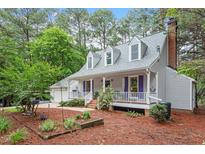 Charming two-story home with a welcoming front porch and well-maintained landscaping at 4953 Tuckahoe Trce, Wake Forest, NC 27587