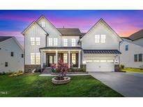 Stunning two-story home with a well-manicured lawn, two-car garage, and brick and white siding exterior at 508 White Oak Branch Ln, Apex, NC 27523