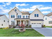 Stunning two-story home featuring a brick-accented porch, two-car garage and manicured lawn at 508 White Oak Branch Ln, Apex, NC 27523