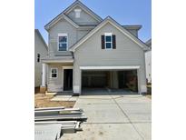 Charming two-story home with a gray exterior, a two car garage and an available sign at 51 Commons Cir, Clayton, NC 27520