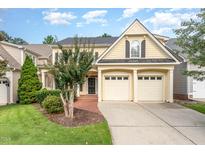 Charming two-story traditional home with a manicured lawn, mature trees, and a convenient two-car garage at 5102 Highcroft Dr, Cary, NC 27519