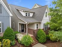 Charming two-story home with manicured landscaping, brick accents, and a welcoming front porch at 5644 Wade Park Blvd, Raleigh, NC 27607