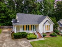 Charming single-Gathering home with a well-manicured lawn and classic architectural details at 6321 Lymington Dr, Raleigh, NC 27616