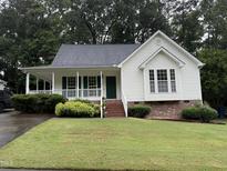 Charming one-story home featuring a welcoming front porch and well-maintained landscaping at 6321 Lymington Dr, Raleigh, NC 27616