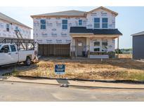 New construction home featuring Tyvek HomeWrap and pre-installed roof, offering a glimpse of future potential at 698 White Birch Ln, Angier, NC 27501