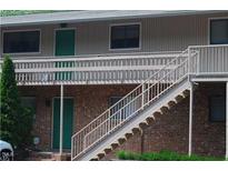 A brick multi-unit building with a staircase leading to the second floor deck at 7 Shepherd Ln # Bldg D, Chapel Hill, NC 27514