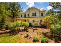 Charming two-story home with a well-manicured yard, mature trees, and a welcoming front porch at 815 Solitude Pt, Chapel Hill, NC 27516